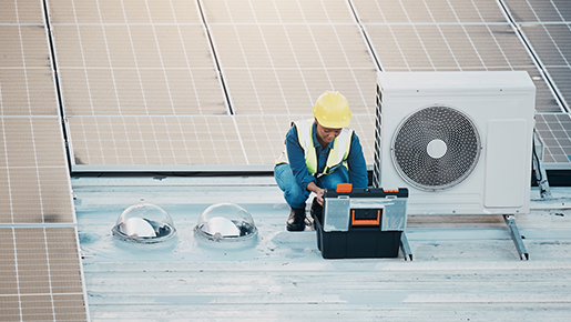 Person in hard hat with solar panels